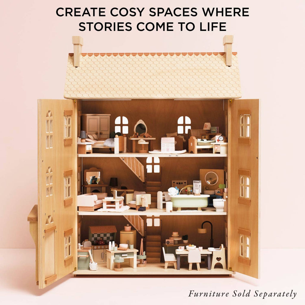 The Grand Natural Wood Doll House features three floors of sustainable wood and includes miniature furniture. Text above: "Create cosy spaces where imaginative play comes to life." Note: Furniture sold separately.