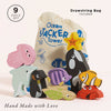 Nine colorful wooden ocean animal toys—including a shark, jellyfish, orca, starfish, crab, fish, and penguin—are displayed with the "Ocean Life Stacking Animals & Bag," making them perfect for sensory play and stacking fun.