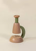 The Little Scientist Wooden Microscope features a modern, minimalist design with a green metal handle, rounded wooden top, and circular base—perfect as a unique science toy for kids—set against a neutral beige background.