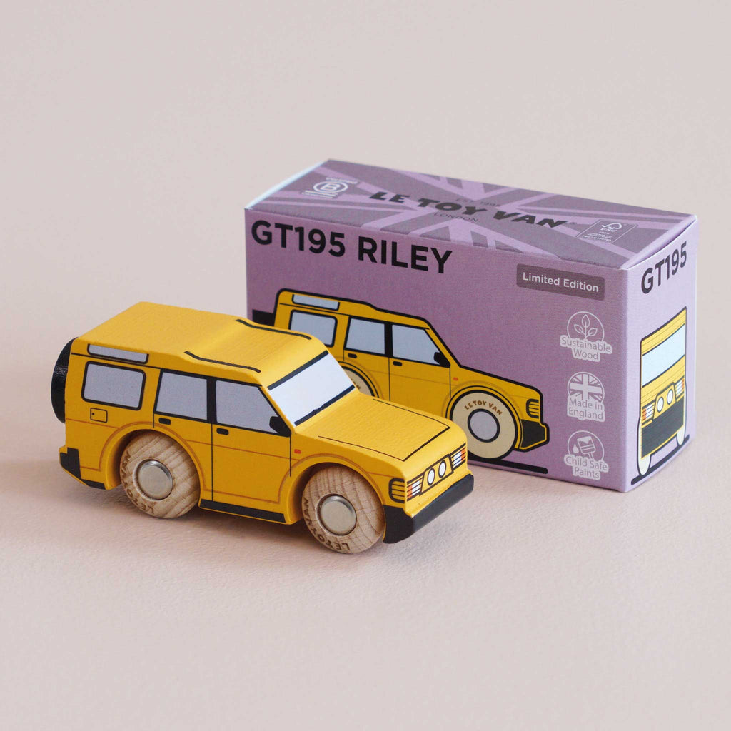 A yellow wooden adventure toy SUV is displayed beside its purple and yellow box labeled “No. 35 GT195 Riley | Made in England.” The packaging features an illustration of the wooden 4x4 vehicle along with icons highlighting sustainable wood and British design.