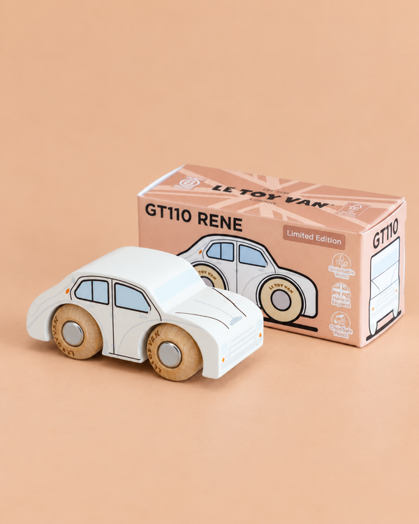 A white wooden toy car with black outlines sits in front of a pink box labeled “No. 20 GT110 Rene | Made in England” on a beige background, inviting imaginative play with this classic toy.