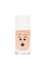 A bottle of peach-colored, water-based Nailmatic nail polish with a Flamingo cartoon face design on the front, featuring eyes with lashes and black lips, against a white background.