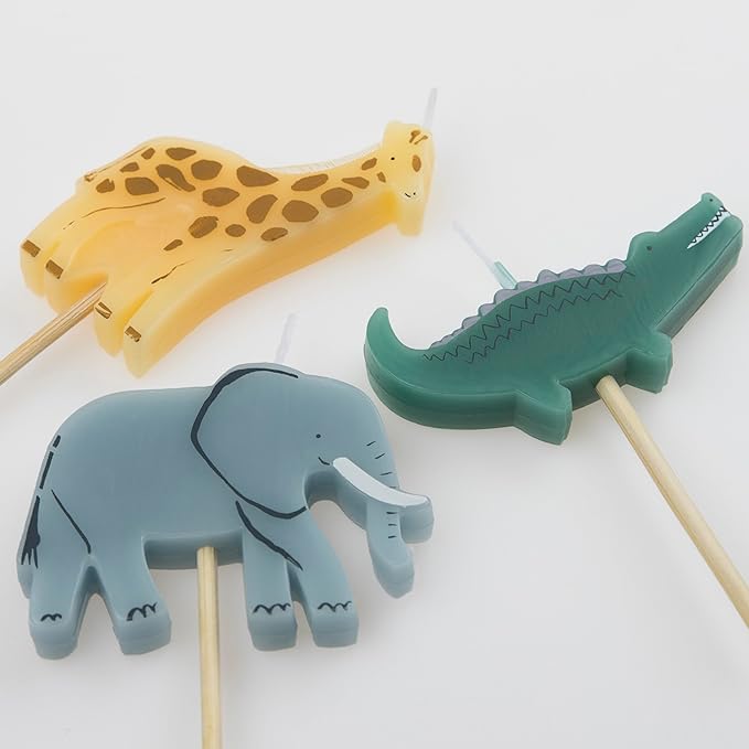 Three Meri Meri Jungle Animal Candles, depicting a giraffe, an elephant, and a crocodile, displayed on a light background for a jungle party.