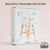 A box featuring the Dolls Wooden High Chair, an eco-friendly pretend play toy, is shown against a light background. The white packaging with product images is labeled "Beautifully packaged for gifting" and "100% recyclable packaging.