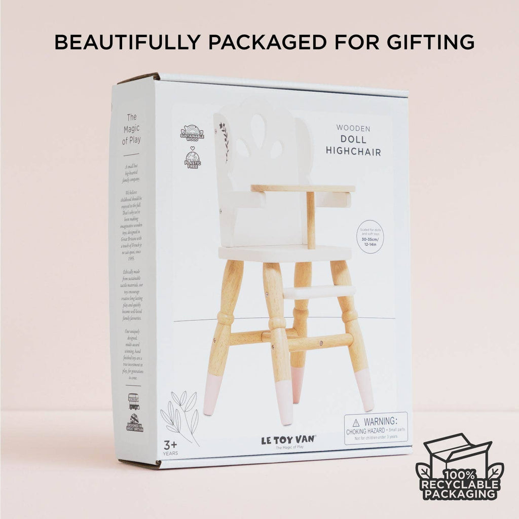 A box featuring the Dolls Wooden High Chair, an eco-friendly pretend play toy, is shown against a light background. The white packaging with product images is labeled "Beautifully packaged for gifting" and "100% recyclable packaging.