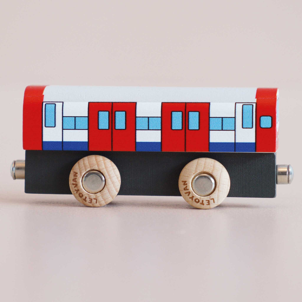 Introducing the No. 48 GT290 Tim, made in England—a wooden toy train car with bold red, white, and blue accents. It features four illustrated doors and is set atop two natural wood wheels, making it perfect for imaginative metro transport play or any wooden toy car adventures.
