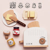 The Pop-up Toaster & Breakfast Set ships in one week and includes bread, butter, honey, jam, and utensils made from FSC-certified wood. Icons highlight its benefits: coordination, imagination, dexterity, and social skills for pretend play.