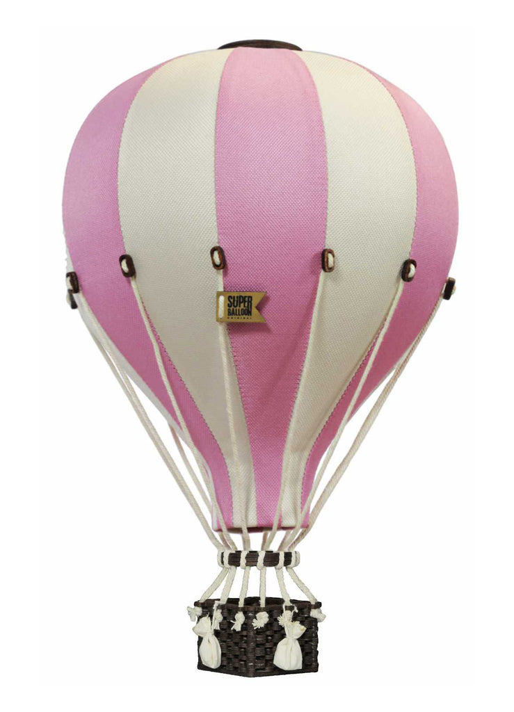 The Hot Air Balloon - Powder Pink features pink and white stripes with a small brown basket attached by white ropes. Isolated on a white background, it’s perfect as handmade children’s room decor. The yellow label reads "SUPER BALLOON.