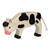 The Holztiger Calf, Grazing is a handcrafted wooden toy featuring painted black spots, a pink snout, and a braided white rope tail. Standing on four legs, it is made in Europe.