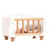 Wooden Dolls Cot in white and natural wood with spindle railings, containing a soft bedding set for dolls.