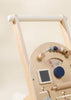 Close-up of the Wooden Activity Walker, showcasing sensory toys such as a bead maze, spinning gear, mirror, and tactile elements in soft, neutral colors.