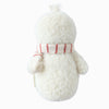 The Cuddle + Kind Baby Snowman - Candy Cane is a fluffy white plush toy with a round head, seen from behind, wearing a hand-knit red and white Peruvian alpaca yarn scarf—perfect as a winter collectible doll.