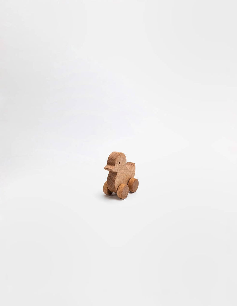 The Sabo Concept Rolling Duck - Natural is a small wooden toy duck on wheels, crafted from natural materials and displayed against a plain white background.