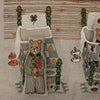 The Coral & Tusk Three Little Bears Pocket Pillow features an embroidered bear in striped pajamas by a patchwork quilt bed, with beds and rabbit toys in the background—perfect as a decorative kids pillow or storybook pocket. Ships in one week.