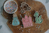 Sure! Here's a rewritten version using the given product data: A delightful assortment of decorated sugar cookies shaped like a princess, castle, carriage, and dragon are arranged on a wooden board alongside a bowl of vibrant star-shaped sprinkles and scattered loose sprinkles. This enchanting scene is perfect for sparking imaginative play—pair it with our Princess Cutter Set - Eco Playdough Tool to extend the magical adventures beyond snack time.