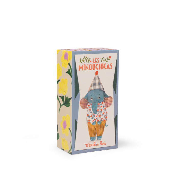A rectangular box featuring Moulin Roty Pablo the Elephant from The Minouchkas, illustrated in yellow pants and a checkered hat by Lucille Michieli, with floral designs on a light background.