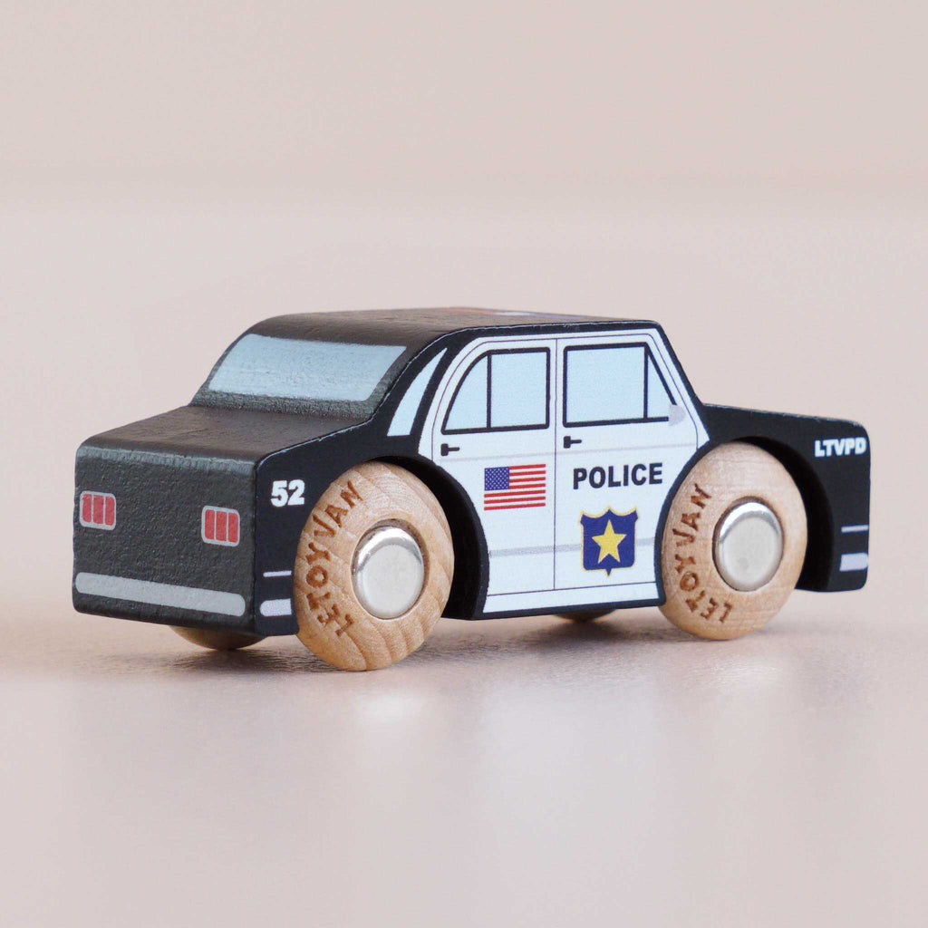 Introducing the No. 41 GT255 Sam, made in England—a classic wooden police car with black and white accents, authentic police decals, and sturdy wooden wheels, perfect for sparking imaginative play against a light background.