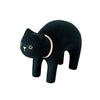 A small, minimalist, black cat figurine with rounded features and simple, white facial markings stands on four legs. Handcrafted from Albizia wood and hand-painted, the Handmade Tiny Wooden Animals - Black Cat sports a light beige collar around its neck, adding a subtle contrast to its dark body.