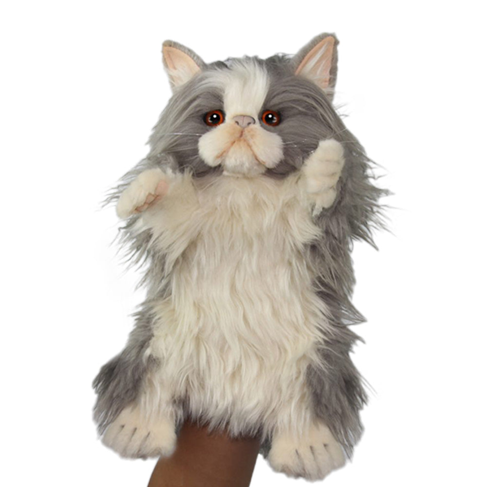 A hand holds the Tabby Cat Puppet upright, its gray and white fur and orange eyes giving it a lifelike look—just like one of those realistic stuffed animals from HANSA.