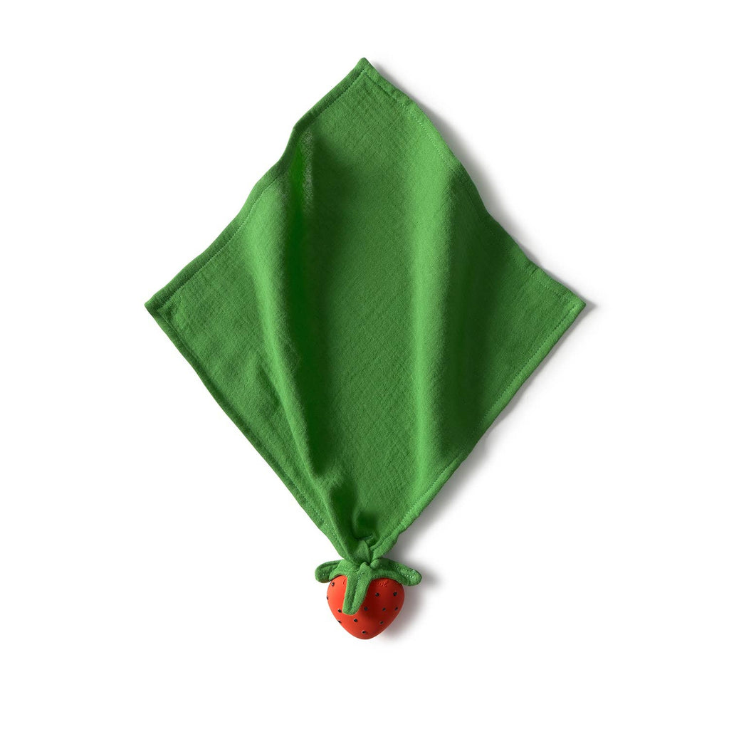 Sweetie the Strawberry Big Doudou, a green organic cotton napkin, is folded into a diamond shape with a red strawberry detail at the bottom corner, set against a white background.