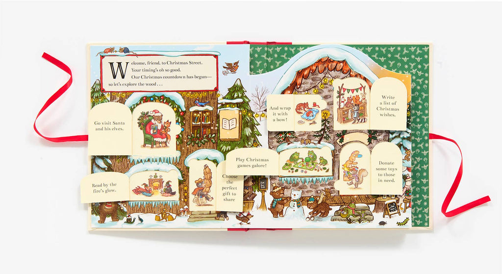 The "Christmas is Coming to Town!" pop-up advent calendar book features festive animal illustrations and interactive flaps that reveal holiday family activities, all accented with vibrant red ribbons.