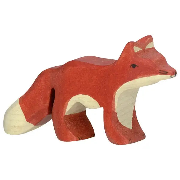 A Holztiger Fox, Small, handcrafted from maple and beech wood, boasts a red body, white-tipped tail, and white patches on its face, chest, and underbelly. The fox stands with a simple design reminiscent of HOLZTIGER figures, featuring painted details for eyes, nose, and mouth.