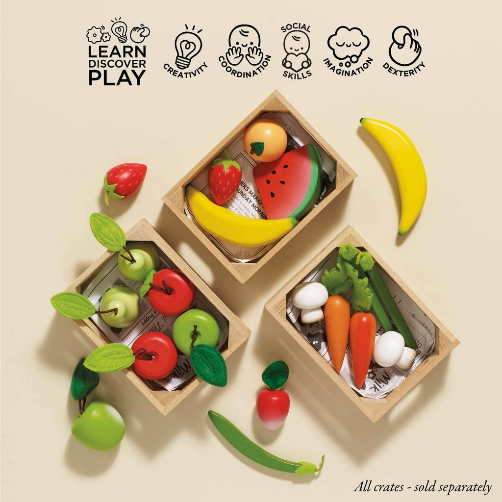 The Smoothie Fruit Wooden Market Crate ships in one week and includes toy apples, carrots, bananas, watermelon, mushrooms, and snap peas—an early-learning toy that sparks imagination, creativity, social skills, and coordination.
