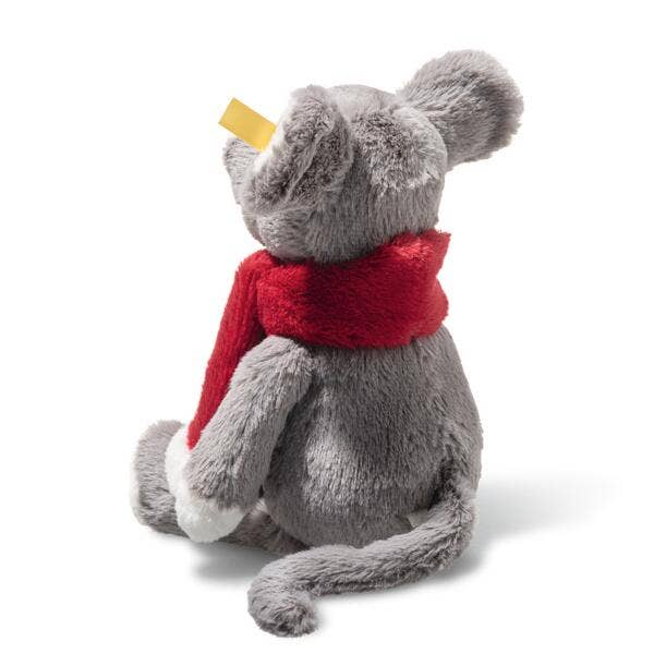 The Steiff Cozy Christmas Mia Mouse, a gray plush toy in a red scarf, sits facing away with yellow cheese balanced on its nose.