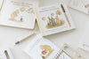 Two illustrated children’s books, including Winnie-the-Pooh: Pooh’s Birthday Surprise (Water Reveal) with a water reveal pen, displayed on a white surface as a no-mess activity book.
