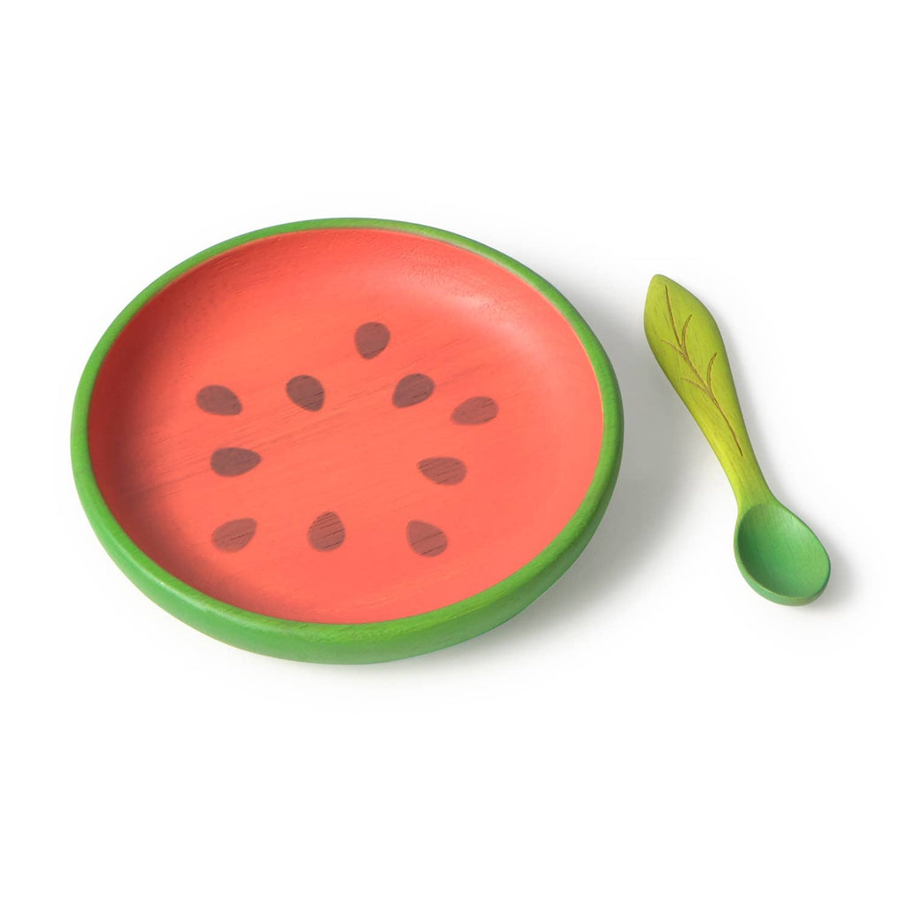 The Wally the Watermelon Plate & Spoon Set features a round, non-toxic plate with a green rim and red center decorated like a watermelon slice, plus a wooden leaf-shaped baby spoon—ideal for stylish baby dinnerware.