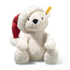 The Steiff Cozy Christmas Rico Polar Bear is a plush white bear sitting upright, wearing a festive red and white Santa hat with a yellow "Steiff" tag in its left ear, set against a plain white background.