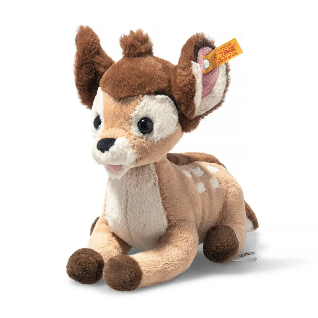 A Disney’s Bambi plush toy depicting a young deer with large, floppy ears, big eyes, and a soft, brown and white fur body, prominently displaying a "Steiff Button in Ear" tag.