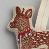 Close-up of the Rudolph Ornament, a cozy fabric decoration shaped like the iconic reindeer. It is brown with embroidered details, featuring a vivid red nose and jingling bells around its neck, perfectly capturing the festive spirit against a neutral background.