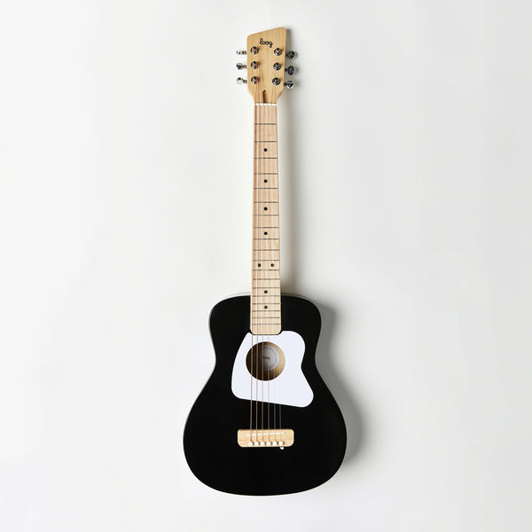 A Loog Pro Vi Acoustic Guitar Ages 9+ (ships in approximately one week) with a beige neck and tuning pegs. It features a white pickguard and six strings, arranged against a plain white background, perfect for practicing with your favorite guitar app.