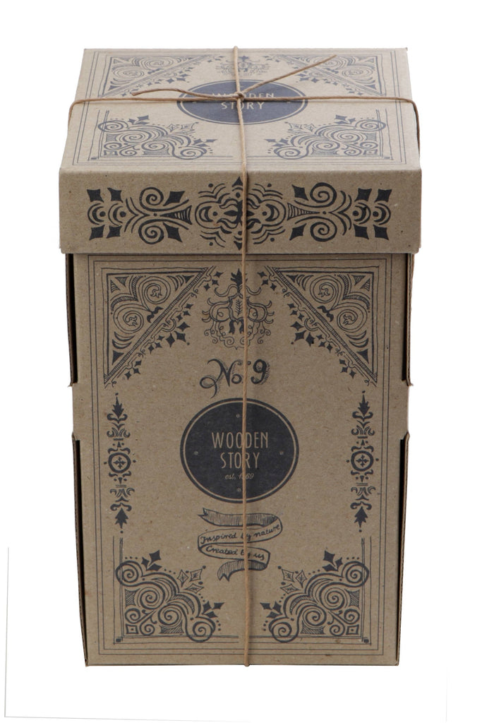 A tall, rectangular cardboard box with black designs and "Wooden Story" branding, secured with twine, holds the Natural Square Pyramid Stacker—an eco-friendly toy made from FSC certified wood.