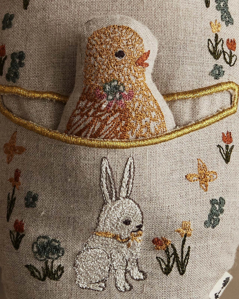 The Coral & Tusk Pocket Easter Egg features an embroidered white bunny with flowers and a yellow chick in a stitched golden pocket—adorable details perfect for any Easter basket.