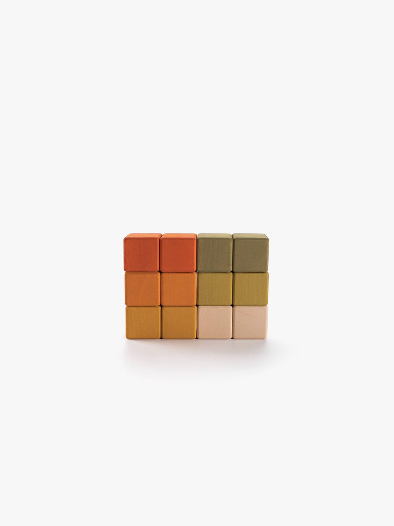 Four rows of four Sabo Concept Mini Wooden Blocks – Flower Meadow are stacked in a rectangle. This educational toy features blocks in orange, mustard yellow, olive green, and light beige tones, arranged vertically by color. Perfect for developing fine motor skills, the set is displayed against a plain white background.