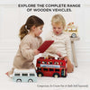 Two young children play with a London Wooden Bus and other wooden vehicles. Text above: "EXPLORE THE COMPLETE RANGE OF WOODEN VEHICLES." Perfect for early learning play.