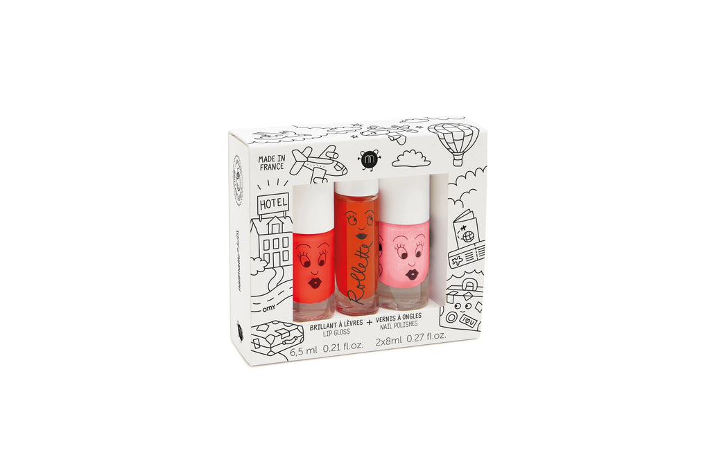 Three Nailmatic - 2 Nail Polish + 1 Lipgloss Set - Amazing Trip tubes with cartoon faces, displayed in front of their illustrated box, showcasing a whimsical cityscape design.