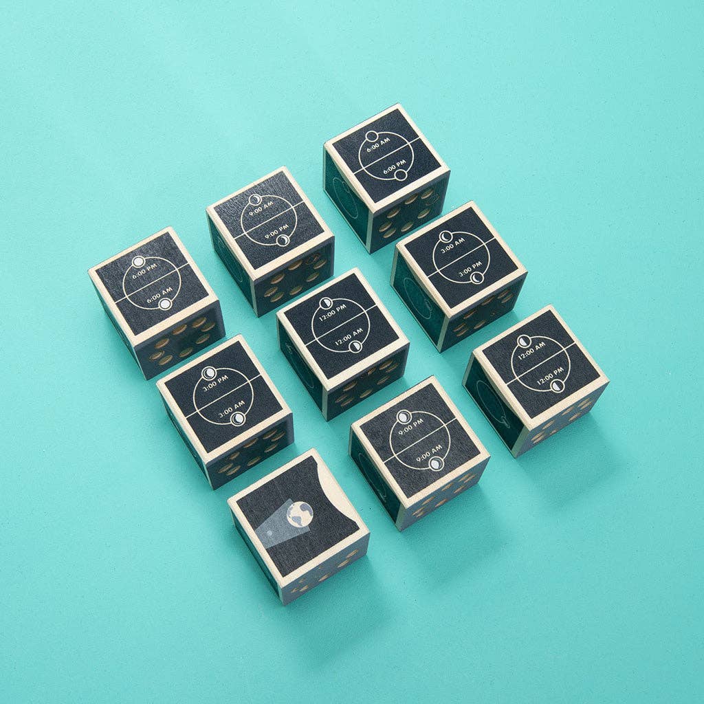 Nine black and wood Uncle Goose Moon Phase Blocks are arranged in a grid on a turquoise background. Each block features white-printed labels and dots on the sides, except for one block, which displays a globe icon instead of the usual markings.