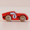 A compact, classic-style red wooden racing car—No. 4 GT25 Finley—crafted in England, featuring the number 8 on its side, sleek black accents, and natural wood wheels, displayed on a light surface.