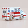A No. 43 GT265 Lance wooden toy ambulance, crafted in England, is displayed on a light surface. Featuring red and white details, wooden wheels, an emergency medical symbol, and the word “AMBULANCE” on the side, it’s perfect for imaginative play and inspires endless rescue adventures for children.