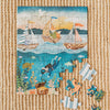 A partially completed Ocean Explorers 40 Piece Mini puzzle is displayed on a woven mat, featuring sailing animals above the water and a diver, turtle, and sea creatures below. Four pieces are set aside in this engaging kids’ jigsaw puzzle.