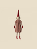 A Maileg Christmas Pixy (Size 6) with a long red pointed hat, wearing an exclusive materials textured brown dress and striped socks, centered against a neutral background.