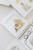 Winnie-the-Pooh: Pooh’s Birthday Surprise (Water Reveal) spiral-bound book showing an illustration of Pooh and Piglet holding a gift, with the text, “Hip, hip, hooray for Pooh! Now it is time to open your present.”