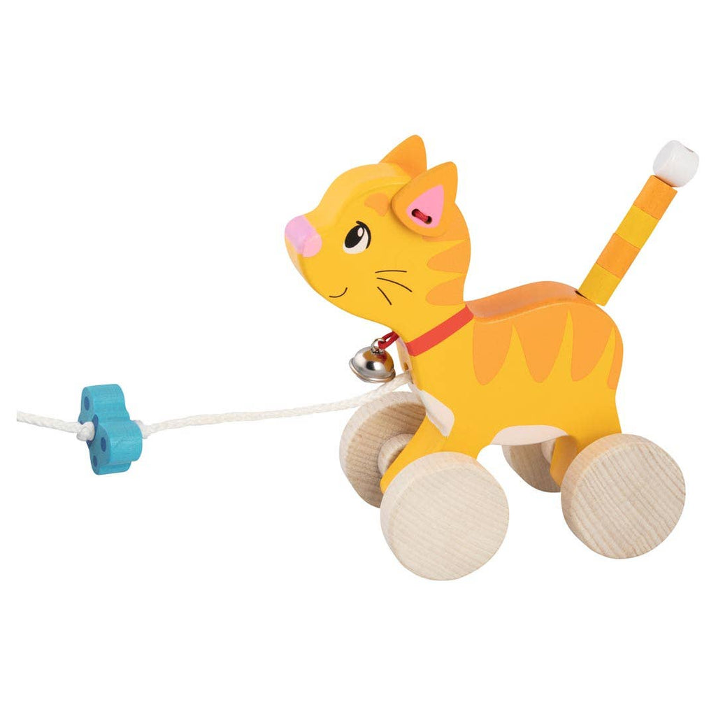 The Holztiger Pull-Along Cat is a charming wooden toddler toy shaped like a yellow cat with orange stripes, a red collar and bell, four natural wood wheels, plus a white string and blue handle for easy pulling fun.