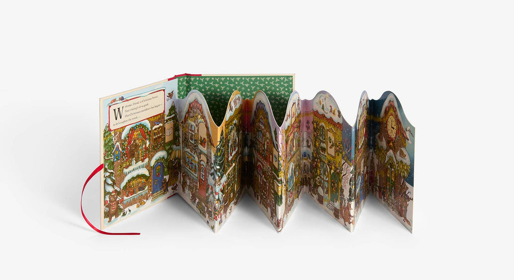 Christmas is Coming to Town! is a colorful, accordion-style pop-up book with festive holiday scenes, detailed buildings, people, and decorations. Perfect as a Christmas advent calendar book, it features a red ribbon on the left side.