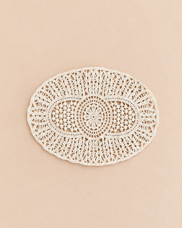 The Maileg Lace Rug, Mouse—a delicately crocheted, oval lace rug with intricate patterns—is displayed on a plain beige background, making it a charming addition to your dollhouse décor or a favorite decorative piece for your interiors.