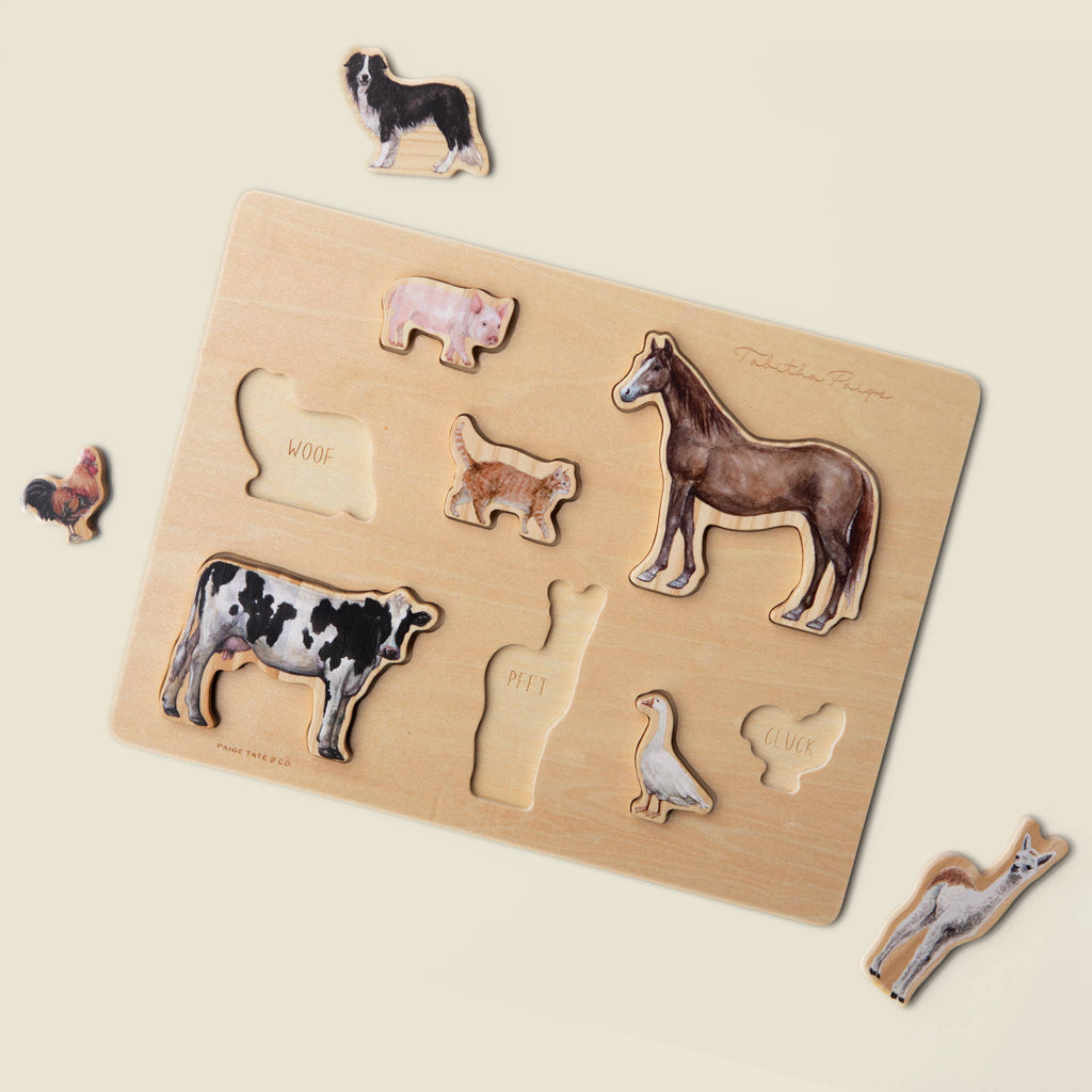 Farm Animals Wooden Puzzle: A Tabitha Paige Puzzle features cutouts for a dog, pig, cat, horse, cow, goose, and rooster. Some animal pieces are set outside their matching slots on a light background—making it an engaging wooden peg puzzle and the perfect educational toy for toddlers.