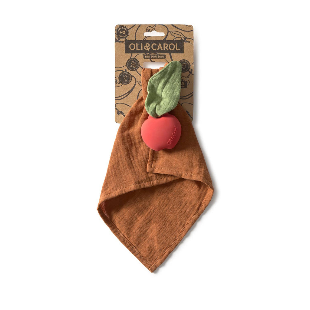 Pepa the Apple Big Doudou is a rust-colored comfort toy made from organic cotton, featuring a red apple-shaped natural rubber teether with green fabric leaves, on branded "Oli & Carol" packaging.